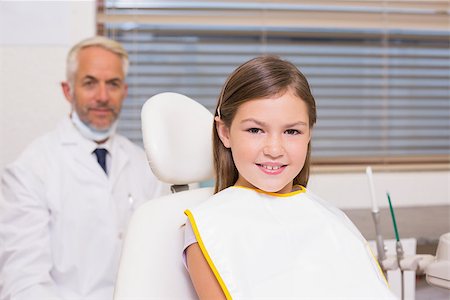 simsearch:400-07684901,k - Pediatric dentist and little girl smiling at camera at the dental clinic Stock Photo - Budget Royalty-Free & Subscription, Code: 400-07684879