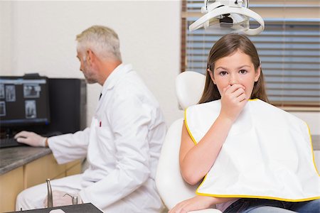 simsearch:400-07684901,k - Terrified little girl looking at camera in dentists chair at the dental clinic Stock Photo - Budget Royalty-Free & Subscription, Code: 400-07684907