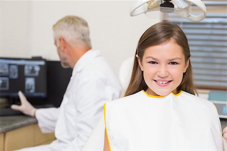 simsearch:400-07684901,k - Smiling little girl looking at camera in dentists chair at the dental clinic Stock Photo - Budget Royalty-Free & Subscription, Code: 400-07684909