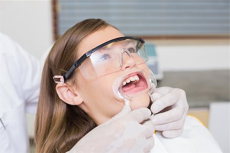 simsearch:400-07684901,k - Dentist putting mouth retractor on little girl at the dental clinic Stock Photo - Budget Royalty-Free & Subscription, Code: 400-07684910