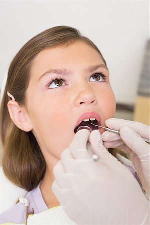 simsearch:400-07684901,k - Pediatric dentist examining little girls teeth in the dentists chair at the dental clinic Stock Photo - Budget Royalty-Free & Subscription, Code: 400-07684927