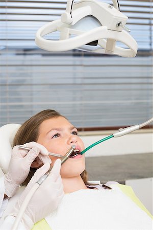simsearch:400-07684901,k - Pediatric dentist examining little girls teeth in the dentists chair at the dental clinic Stock Photo - Budget Royalty-Free & Subscription, Code: 400-07684930