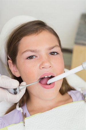 simsearch:400-07684901,k - Pediatric dentist examining a little girls teeth in the dentists chair at the dental clinic Stock Photo - Budget Royalty-Free & Subscription, Code: 400-07684944