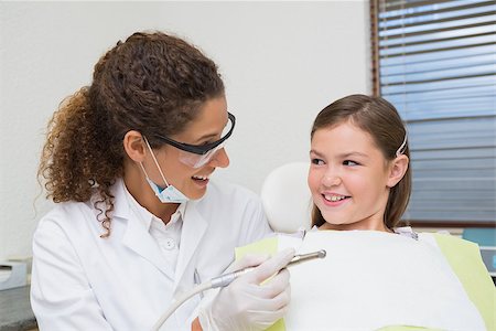 simsearch:400-07684901,k - Pediatric dentist smiling with little girl in the chair at the dental clinic Stock Photo - Budget Royalty-Free & Subscription, Code: 400-07684952