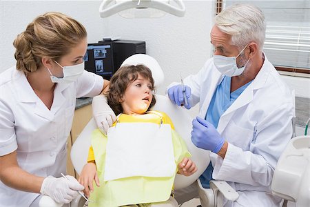 Terrified little boy looking at needle in dentists chair at the dental clinic Stock Photo - Budget Royalty-Free & Subscription, Code: 400-07685048