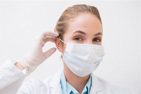 simsearch:400-07941465,k - Dentist putting on her surgical mask at the dental clinic Stock Photo - Budget Royalty-Free & Subscription, Code: 400-07685063