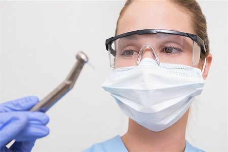 dental drill - Dentist in surgical mask and protective glasses holding drill at the dental clinic Stock Photo - Budget Royalty-Free & Subscription, Code: 400-07685098