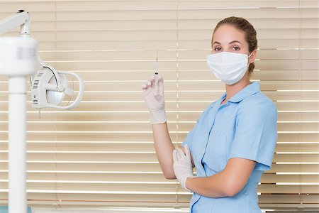 female with dental tools at work - Dental assistant holding injection looking at camera at the dental clinic Stock Photo - Budget Royalty-Free & Subscription, Code: 400-07685117