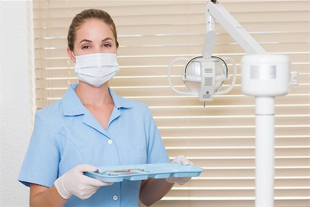 female with dental tools at work - Dental assistant in blue holding tray of tools at the dental clinic Stock Photo - Budget Royalty-Free & Subscription, Code: 400-07685135