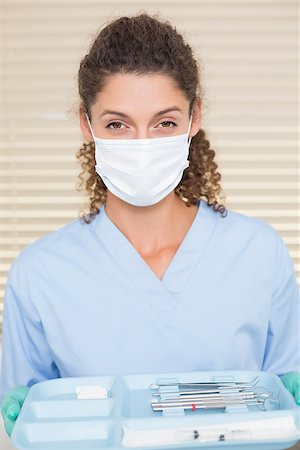 dentist tray - Dentist in blue scrubs holding tray of tools at the dental clinic Stock Photo - Budget Royalty-Free & Subscription, Code: 400-07685181