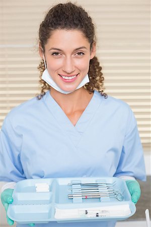 simsearch:400-07941454,k - Dentist in blue scrubs holding tray of tools at the dental clinic Stockbilder - Microstock & Abonnement, Bildnummer: 400-07685182