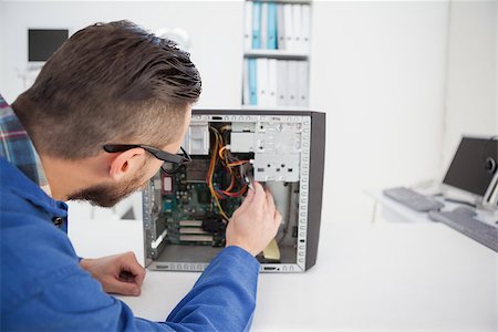 engineer at desk - Computer engineer working on broken console in his office Stock Photo - Budget Royalty-Free & Subscription, Code: 400-07685267