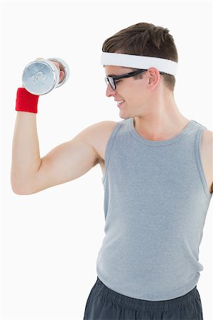 Nerdy hipster lifting heavy dumbbell on white background Stock Photo - Budget Royalty-Free & Subscription, Code: 400-07685613