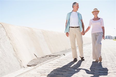 Happy senior couple walking on the pier on a sunny day Stock Photo - Budget Royalty-Free & Subscription, Code: 400-07685736