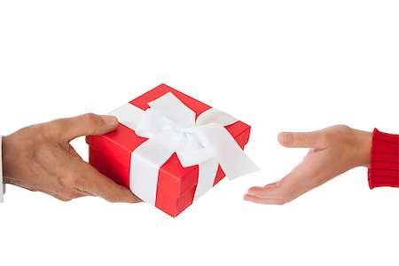 simsearch:400-07726699,k - Couple passing a wrapped gift on white background Foto de stock - Super Valor sin royalties y Suscripción, Código: 400-07685897