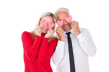 simsearch:400-06690931,k - Silly couple holding hearts over their eyes on white background Fotografie stock - Microstock e Abbonamento, Codice: 400-07685909