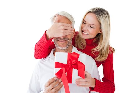 simsearch:400-07726699,k - Smiling woman covering partners eyes and holding gift on white background Foto de stock - Super Valor sin royalties y Suscripción, Código: 400-07685900