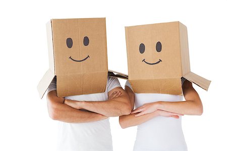 Couple wearing smiley face boxes on their heads on white background Stock Photo - Budget Royalty-Free & Subscription, Code: 400-07685952