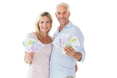 flashing - Happy couple flashing their cash on white background Photographie de stock - Aubaine LD & Abonnement, Code: 400-07686104