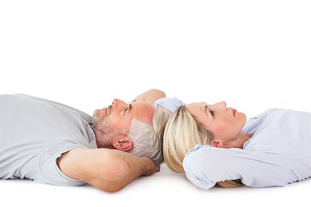 simsearch:400-07726578,k - Smiling couple lying and looking up on white background Fotografie stock - Microstock e Abbonamento, Codice: 400-07686188