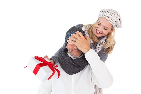 Happy woman holding gift while covering husbands eyes on white background Stock Photo - Budget Royalty-Free & Subscription, Code: 400-07686213