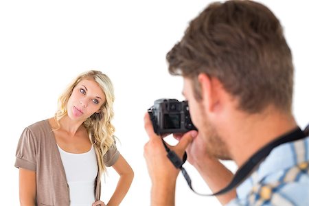 Man taking photo of his girlfriend sticking her tongue out on white background Foto de stock - Super Valor sin royalties y Suscripción, Código: 400-07686338