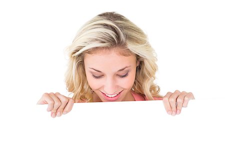 Pretty young blonde showing poster on white background Stock Photo - Budget Royalty-Free & Subscription, Code: 400-07686460