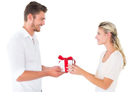 simsearch:400-07686530,k - Attractive young couple holding a gift on white background Foto de stock - Royalty-Free Super Valor e Assinatura, Número: 400-07686516