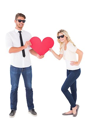simsearch:400-07686534,k - Cool young couple holding red heart on white background Foto de stock - Royalty-Free Super Valor e Assinatura, Número: 400-07686534