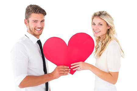 simsearch:400-07726694,k - Attractive young couple holding red heart on white background Foto de stock - Super Valor sin royalties y Suscripción, Código: 400-07686530