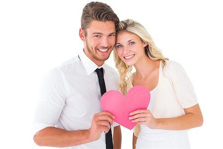 simsearch:400-07726694,k - Attractive young couple holding pink heart on white background Foto de stock - Royalty-Free Super Valor e Assinatura, Número: 400-07686531