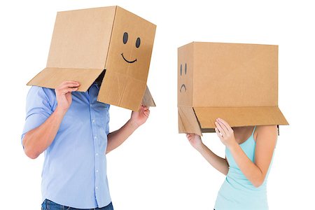 Couple wearing emoticon face boxes on their heads on white background Stock Photo - Budget Royalty-Free & Subscription, Code: 400-07686560