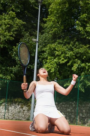 Pretty tennis player celebrating a win on a sunny day Photographie de stock - Aubaine LD & Abonnement, Code: 400-07686778