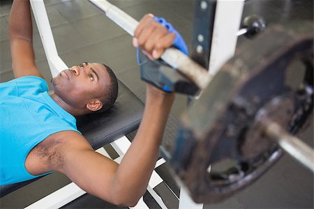 simsearch:400-06208099,k - High angle view of a determined young muscular man lifting barbell in gym Photographie de stock - Aubaine LD & Abonnement, Code: 400-07687909