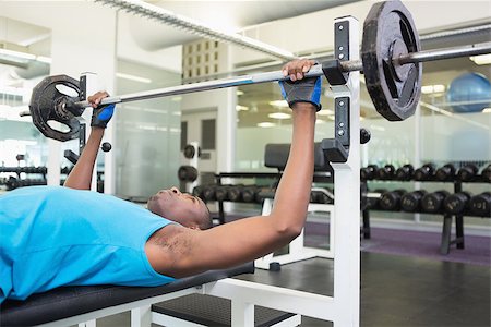 simsearch:400-06208099,k - Side view of a determined young muscular man lifting barbell in gym Photographie de stock - Aubaine LD & Abonnement, Code: 400-07687910