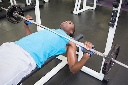 simsearch:400-06208099,k - High angle view of a determined young muscular man lifting barbell in gym Photographie de stock - Aubaine LD & Abonnement, Code: 400-07687911