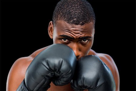 defensive posture - Portrait of a shirtless muscular boxer in defensive stance over black background Foto de stock - Super Valor sin royalties y Suscripción, Código: 400-07688007