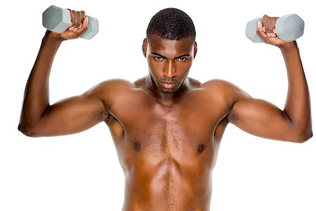 simsearch:400-06208099,k - Determined fit shirtless young man lifting dumbbells over white background Photographie de stock - Aubaine LD & Abonnement, Code: 400-07688030