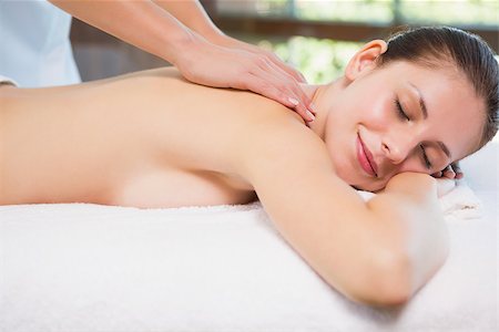 simsearch:400-07723724,k - Side view of an attractive young woman receiving back massage at spa center Photographie de stock - Aubaine LD & Abonnement, Code: 400-07688132