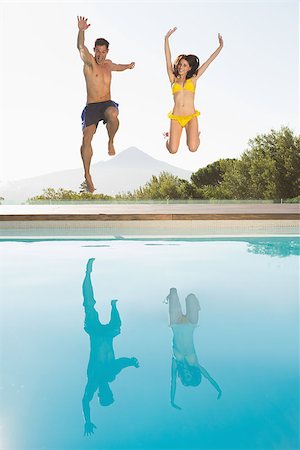 Full length of a cheerful young couple jumping into swimming pool Stock Photo - Budget Royalty-Free & Subscription, Code: 400-07688291