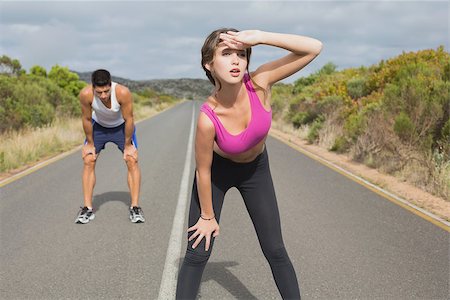 simsearch:400-07688341,k - Fit young couple running on the open road together Stock Photo - Budget Royalty-Free & Subscription, Code: 400-07688335