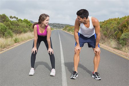 simsearch:400-07688341,k - Fit young couple running on the open road together Stock Photo - Budget Royalty-Free & Subscription, Code: 400-07688336