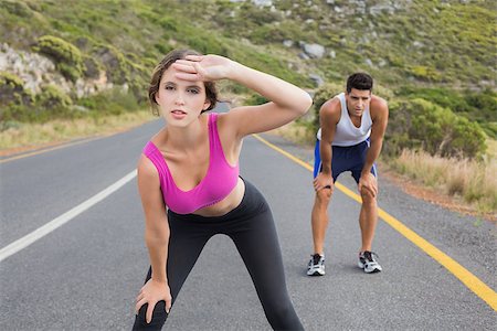 Fit young couple running on the open road together Stock Photo - Budget Royalty-Free & Subscription, Code: 400-07688342