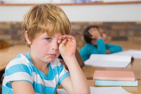 Upset pupil sitting at his desk at the elementary school Stock Photo - Budget Royalty-Free & Subscription, Code: 400-07688642