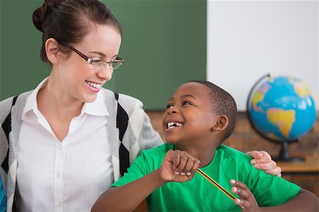 simsearch:400-07991069,k - Cute pupil and teacher smiling at each other in classroom at the elementary school Foto de stock - Royalty-Free Super Valor e Assinatura, Número: 400-07688707