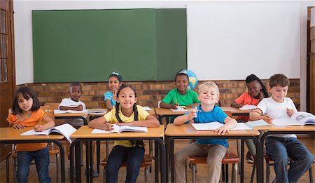 simsearch:400-07991069,k - Cute pupils smiling at camera in classroom at the elementary school Foto de stock - Royalty-Free Super Valor e Assinatura, Número: 400-07688708