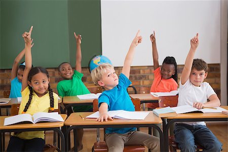 simsearch:400-07991069,k - Cute pupils raising their hands at the elementary school Foto de stock - Royalty-Free Super Valor e Assinatura, Número: 400-07688709