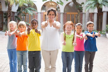simsearch:400-07684082,k - Pretty teacher standing with pupils in courtyard at the elementary school Stock Photo - Budget Royalty-Free & Subscription, Code: 400-07688817