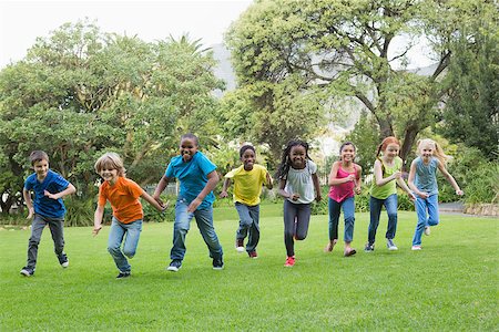 Cute pupils racing on the grass outside at the elementary school Stock Photo - Budget Royalty-Free & Subscription, Code: 400-07688826