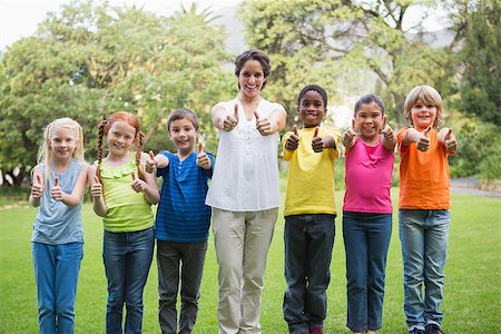 simsearch:400-07684082,k - Pretty teacher standing with pupils outside at the elementary school Stock Photo - Budget Royalty-Free & Subscription, Code: 400-07688820